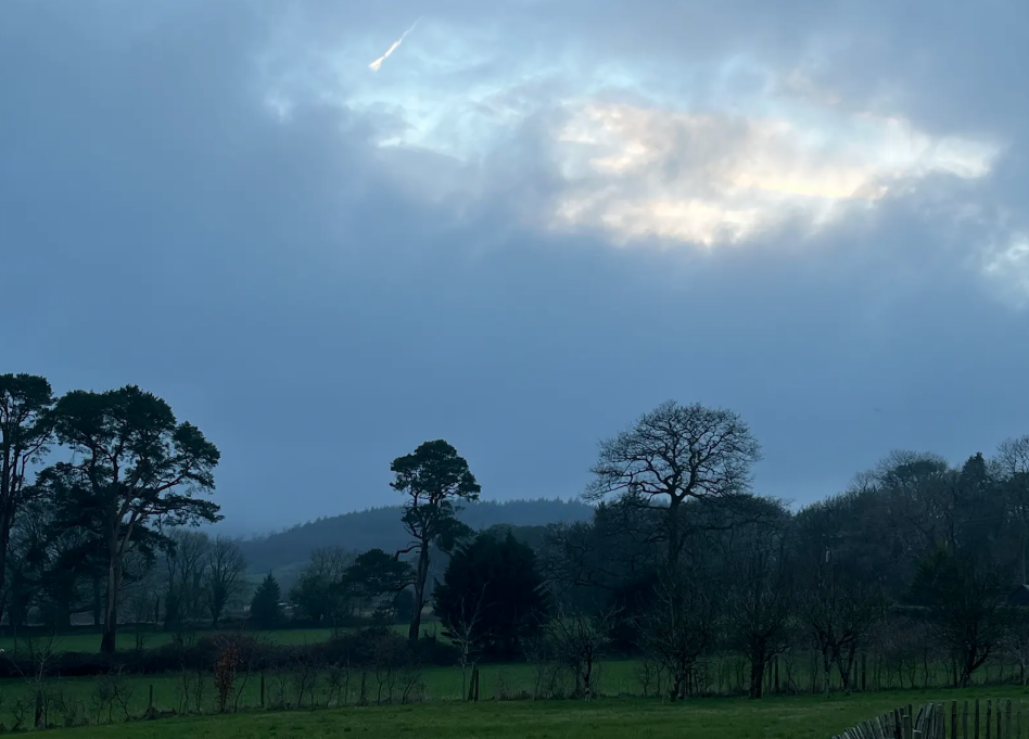 Blue hour over the fields, cloud breaking open